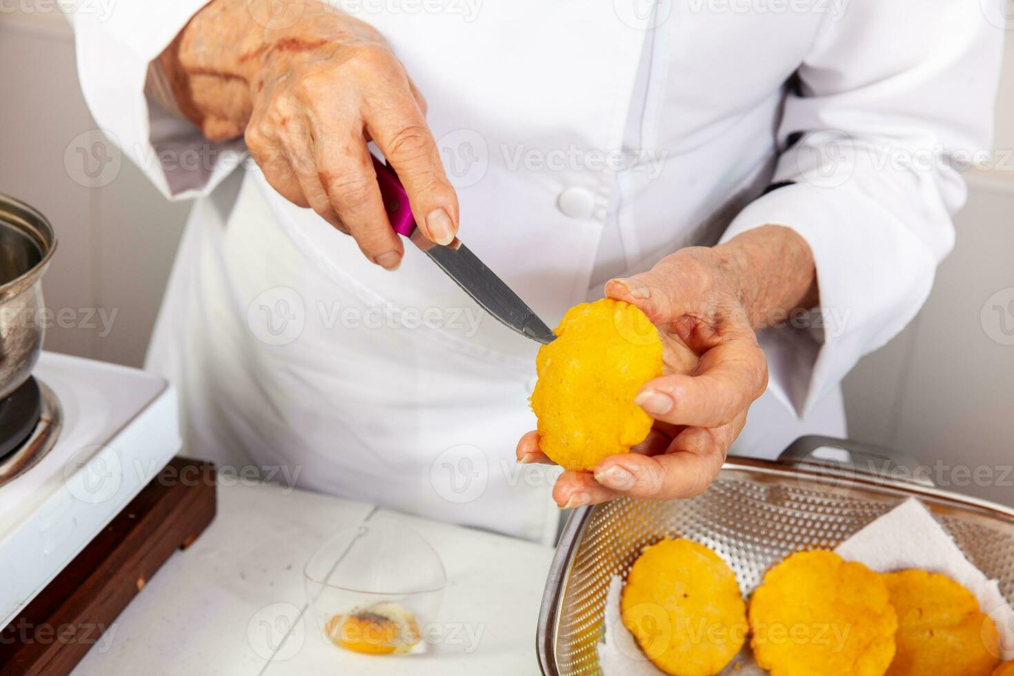 Preparation of the traditional dish from the Caribbean Coast in colombia called Arepa de Huevo or egg arepa photo