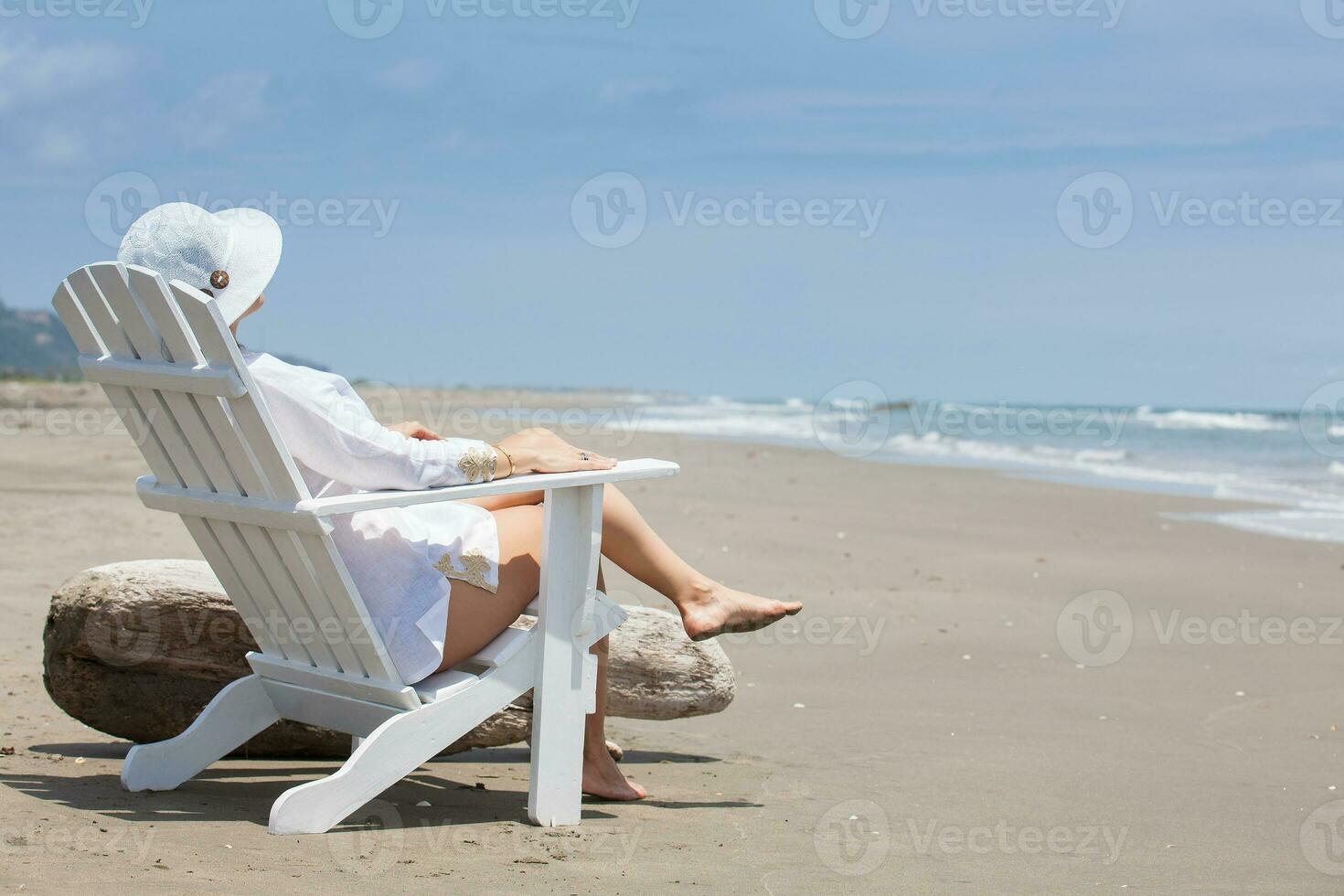 Woman relaxing at a paradisiac tropical beach in a beautiful sunny day photo