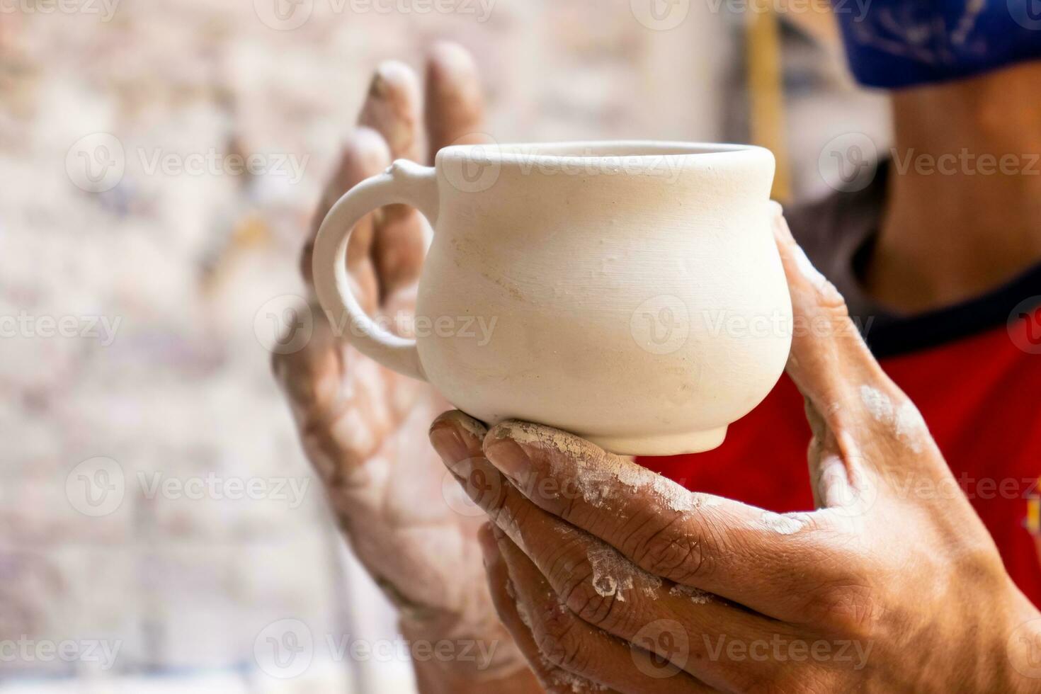 Ceramics on the elaboration process at a traditional factory at the small city of Raquira in Colombia photo