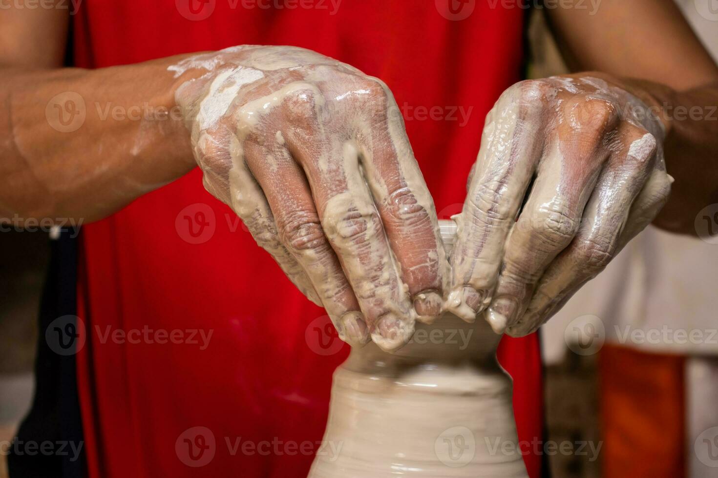 Man making ceramic articles on the potters wheel in a traditional factory in the city of Raquira located in the department of Cundinamarca in Colombia photo