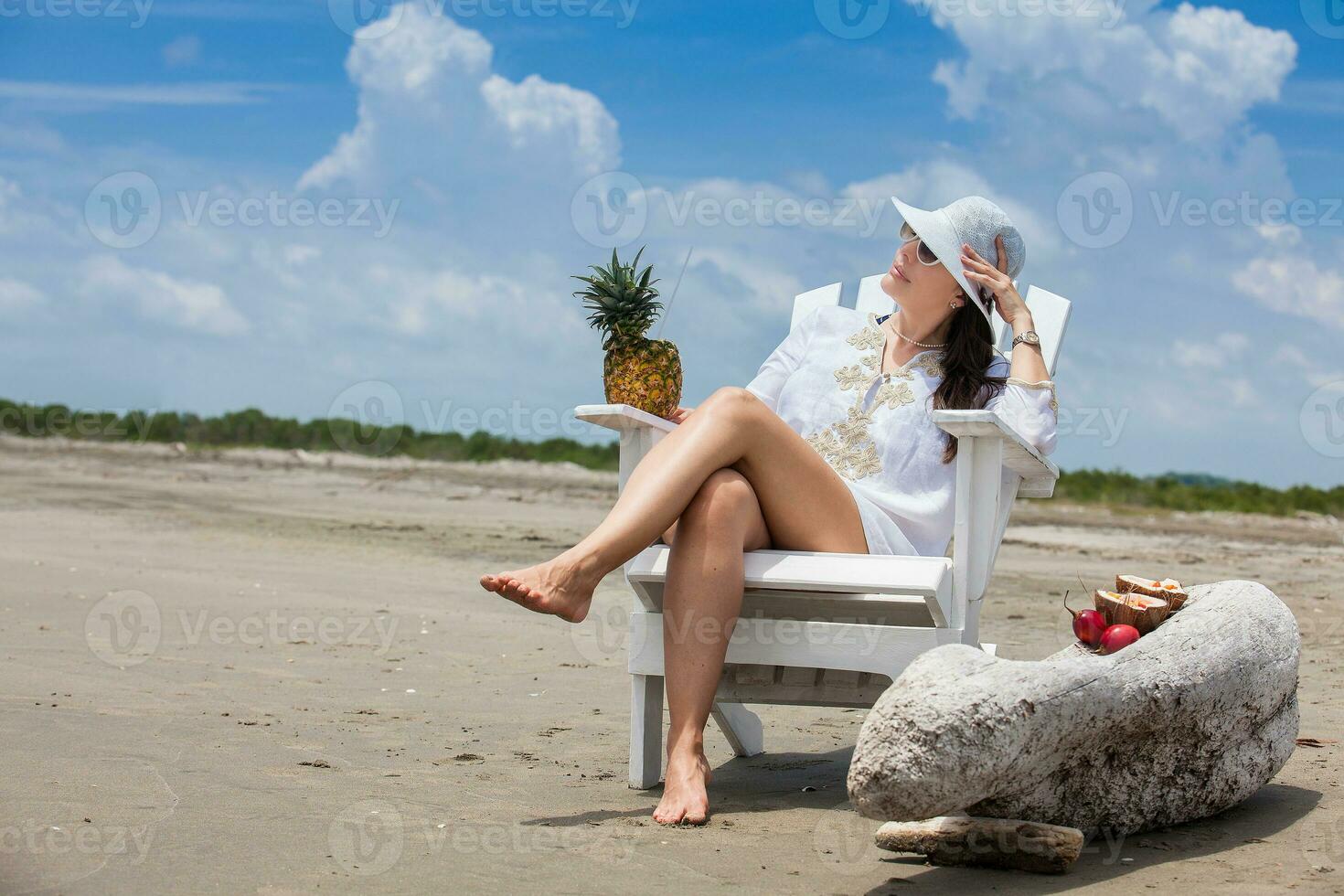 Woman relaxing at a paradisiac tropical beach in a beautiful sunny day photo