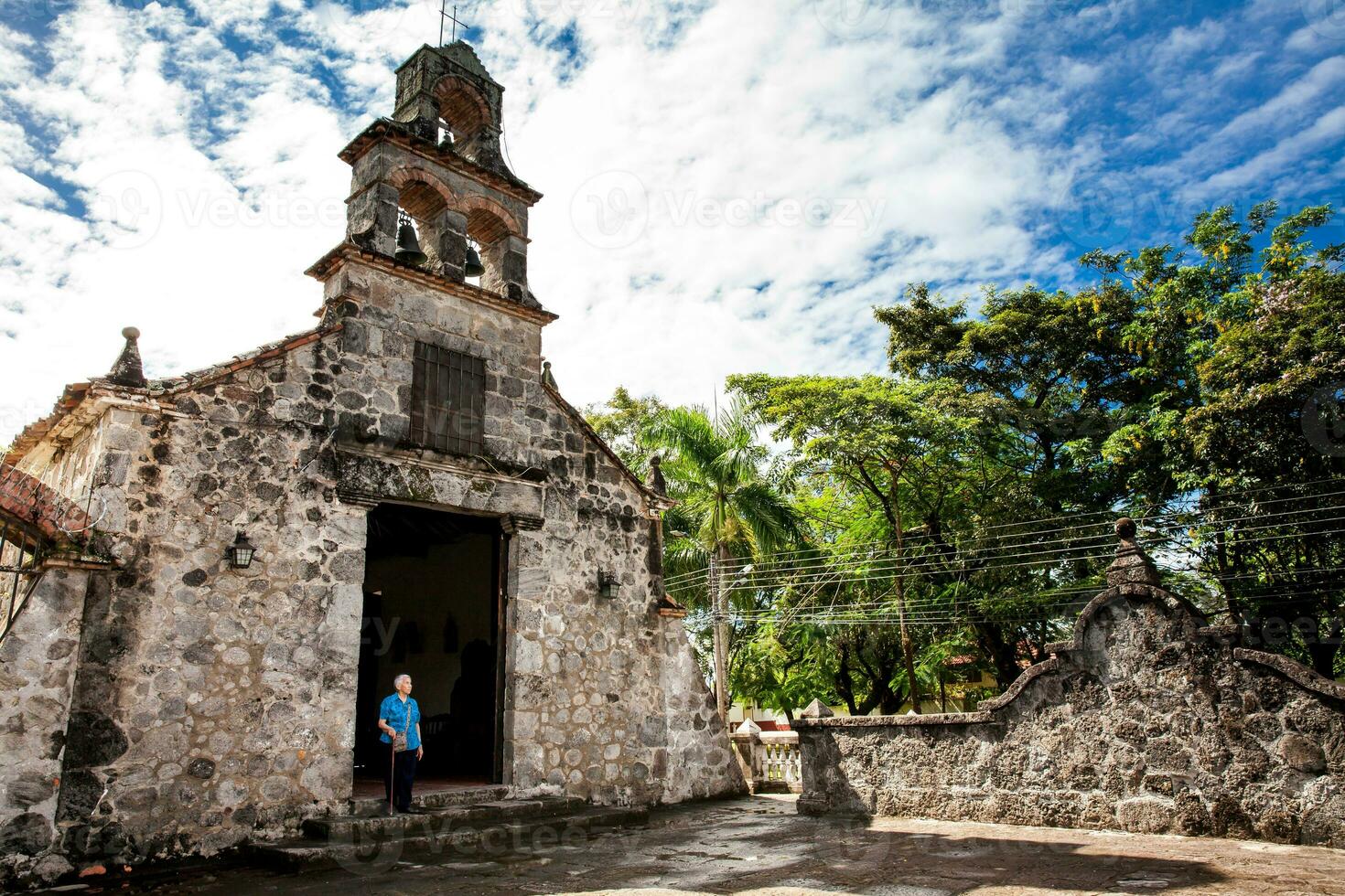 Senior woman at the beautiful historical church La Ermita built in the sixteenth century in the town of Mariquita in Colombia photo