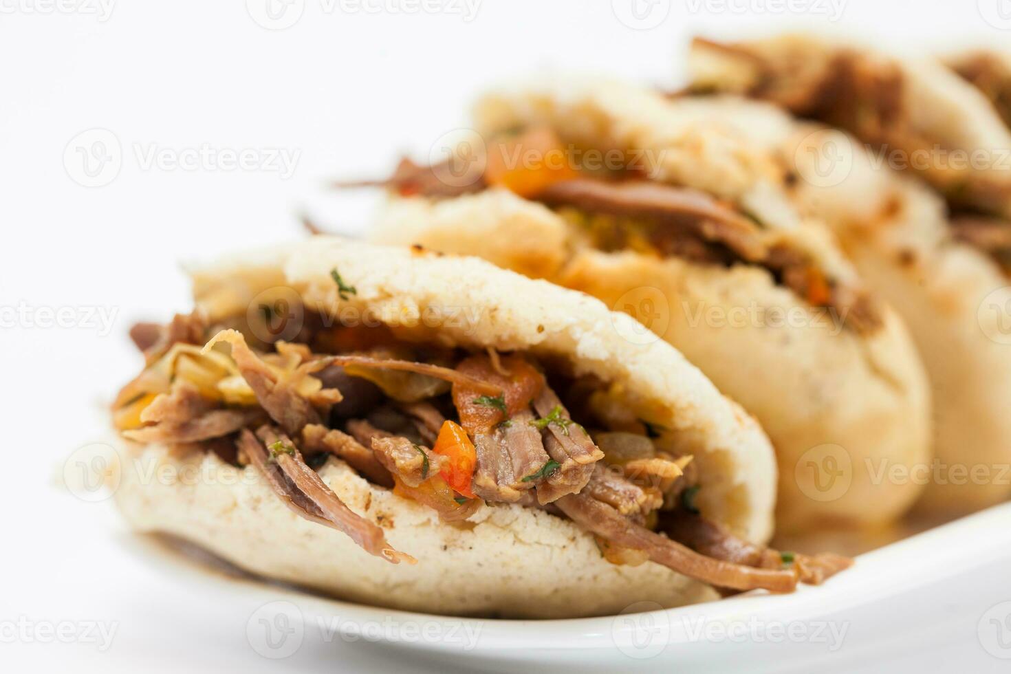 Traditional Colombian arepa filled with shredded beef photo