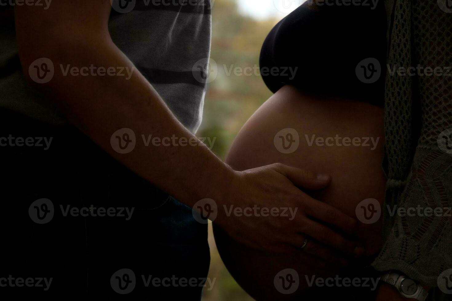 Backlight of a couple waiting for their baby - 38 weeks photo