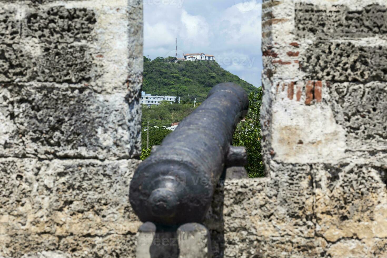 Walls of Cartagena de Indias built at the end of the XVI century for the defense of the city. Ancient cannon on the wall pointing towards Cerro de la Popa. photo