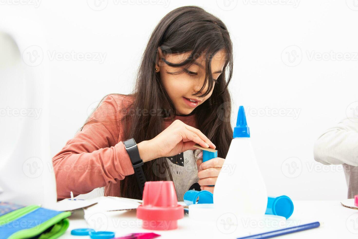 Young girl making a toy microscope with recyclable material photo
