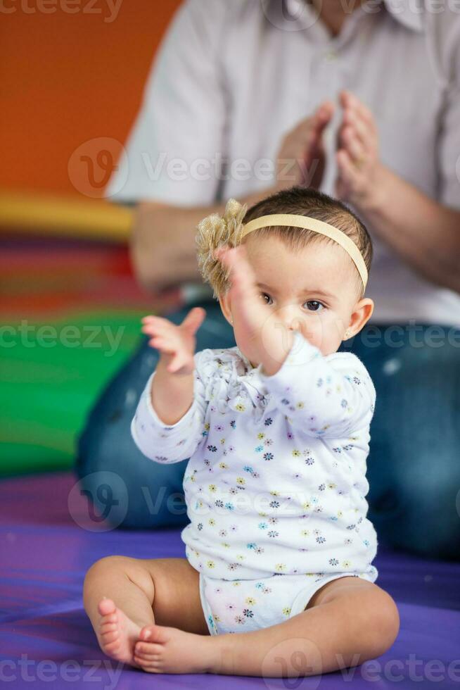 Portrait of a beautiful nine months baby playing with her dad. photo