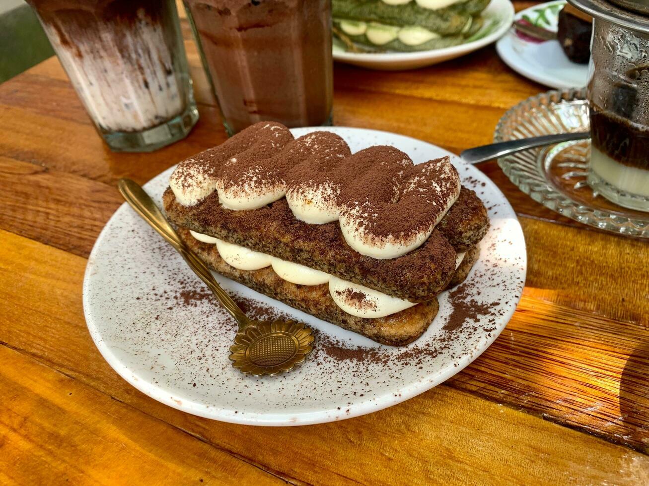 Tiramisu, Italian layered dessert with mascarpone cream, garnished with cocoa powder. photo