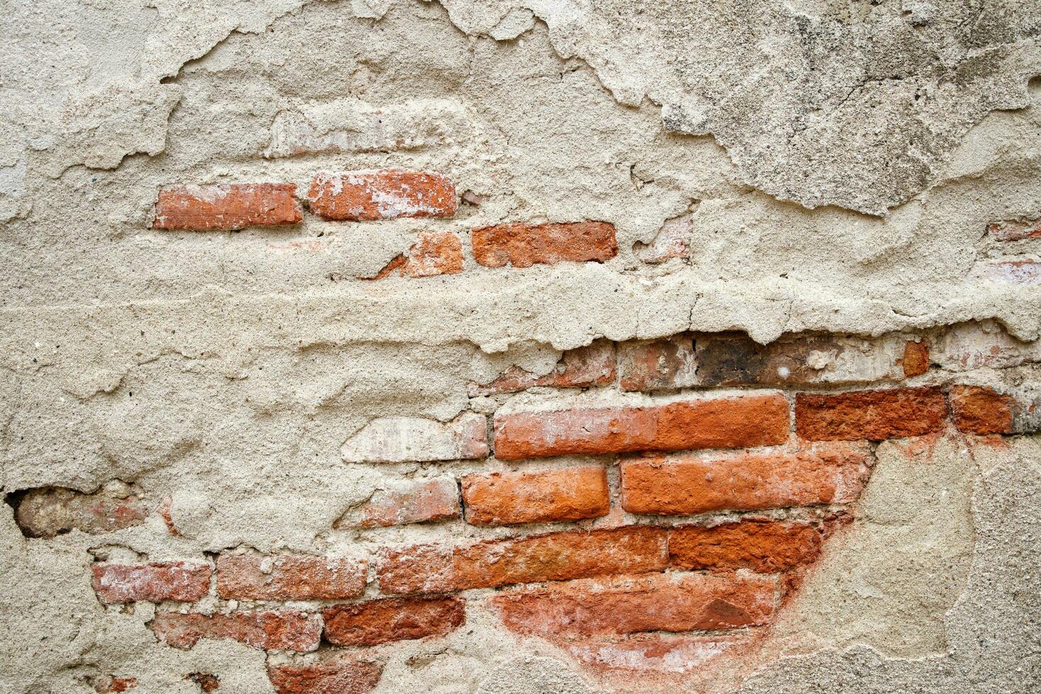 very cracked old wall background texture with red bricks inside photo