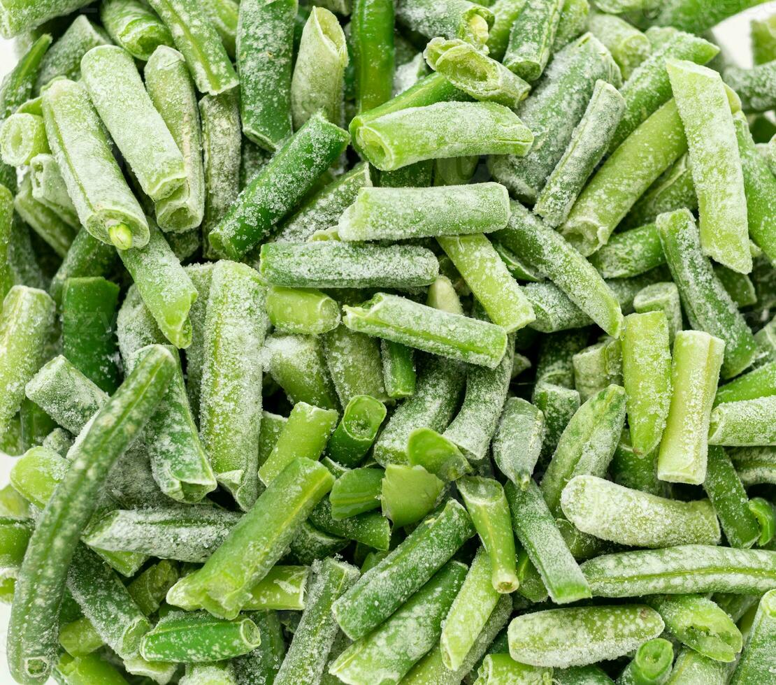 Frozen cut green string beans close up as background. Real food. Sustainable consumption. Top view. photo