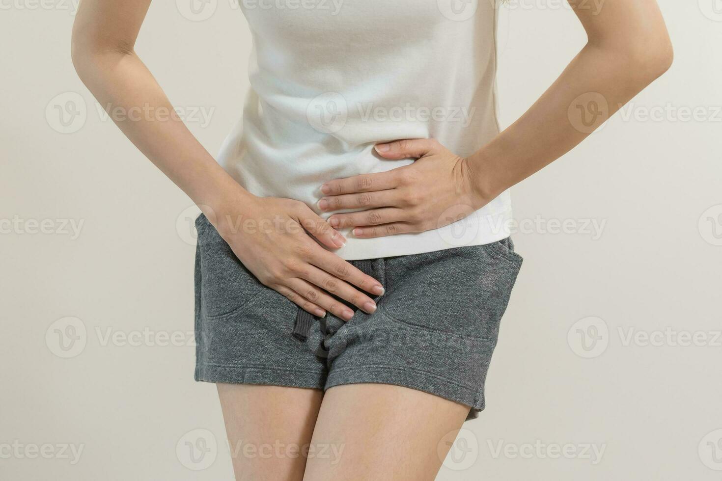 Vaginal, urinary incontinence. Pain asian young woman hand holding