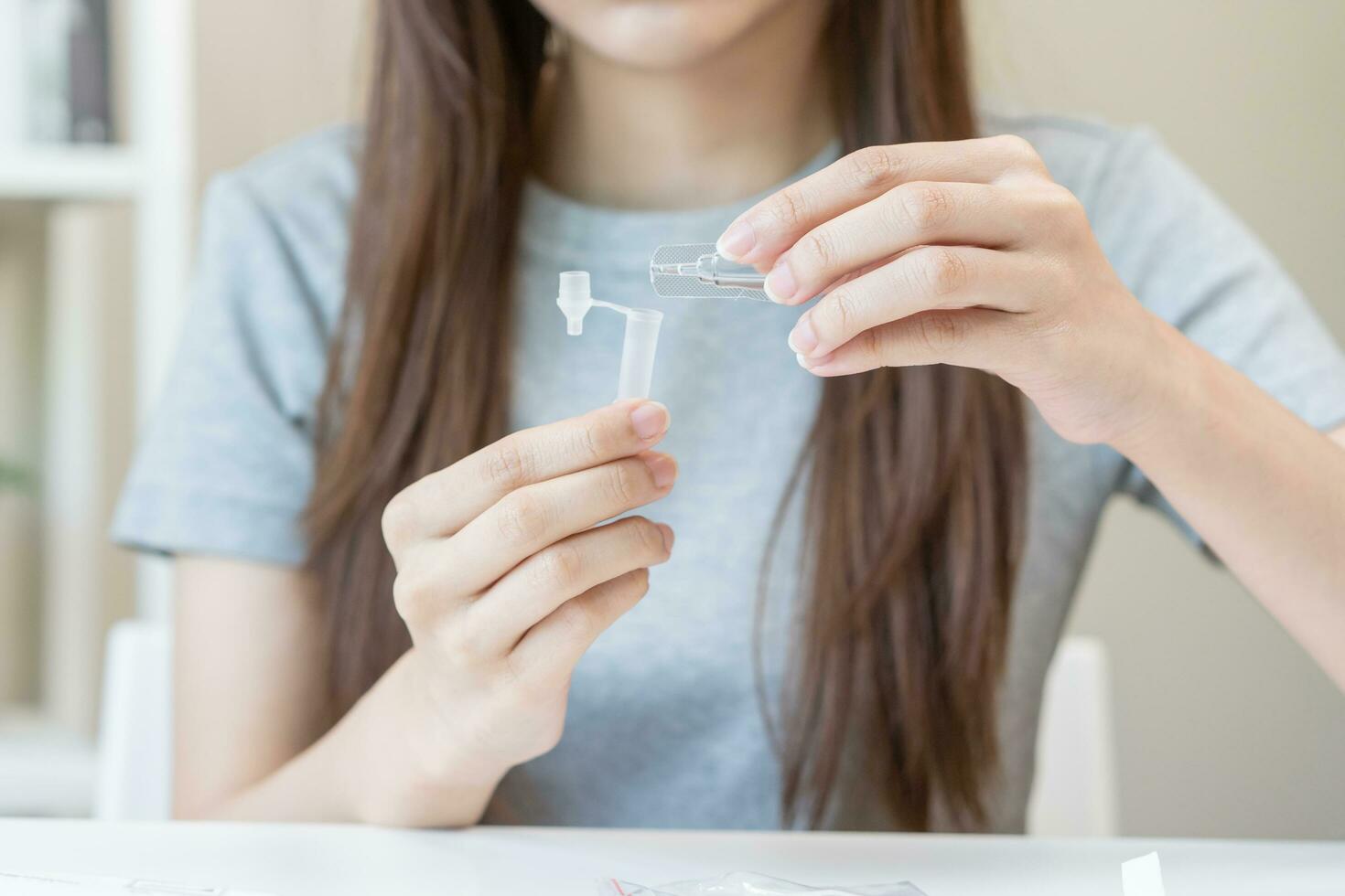 Pandemic of disease, asian young woman, girl hand holding atk, antigen kit self test. Introducing device nasal, nose swab test for possible infection of coronavirus, covid-19 at home. Health care. photo