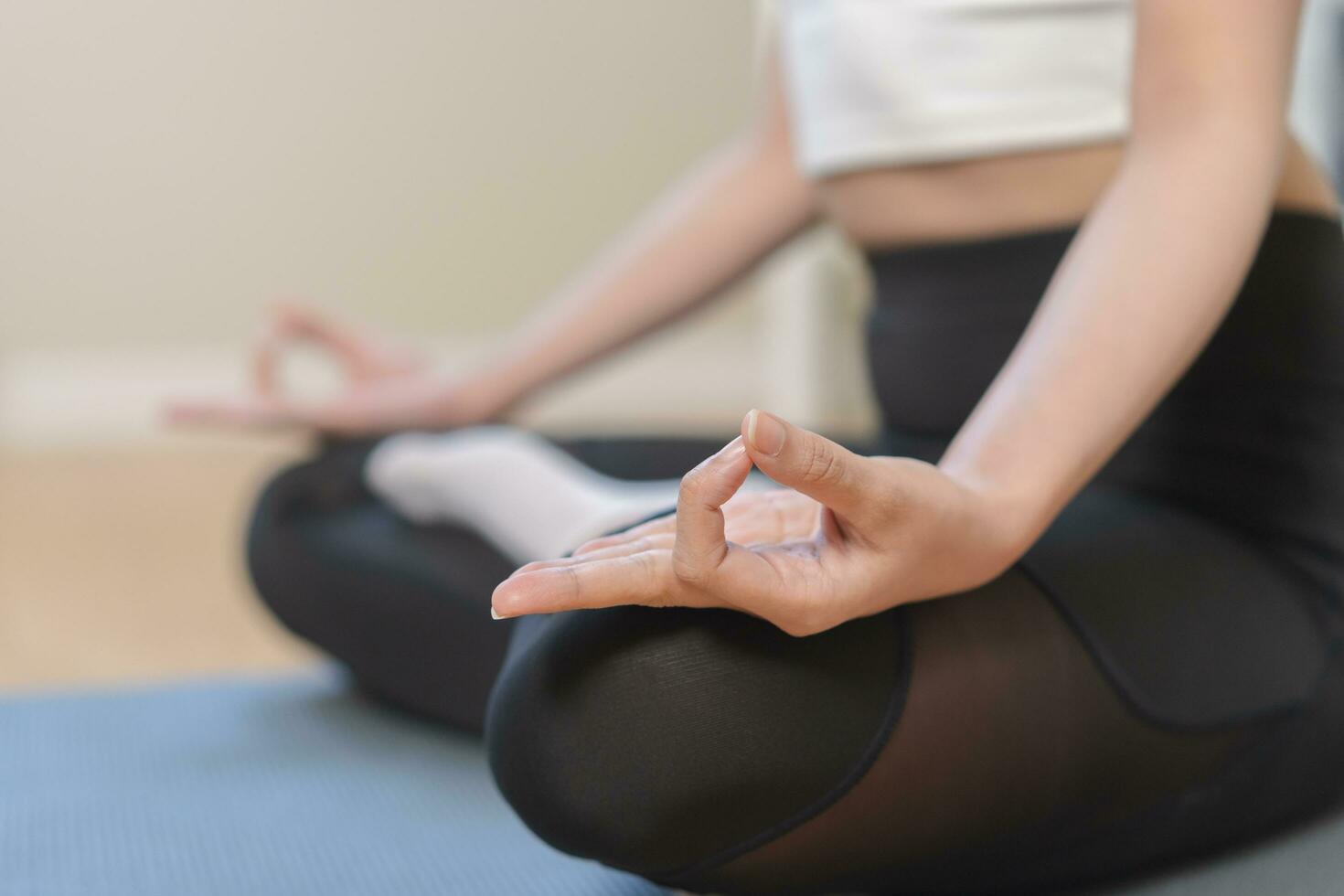 Workout, calm asian young woman, girl hand in calm pose sitting practice meditating in lotus position on mat at home, meditation, exercise for wellbeing, healthy care. Relaxation, happy leisure. photo