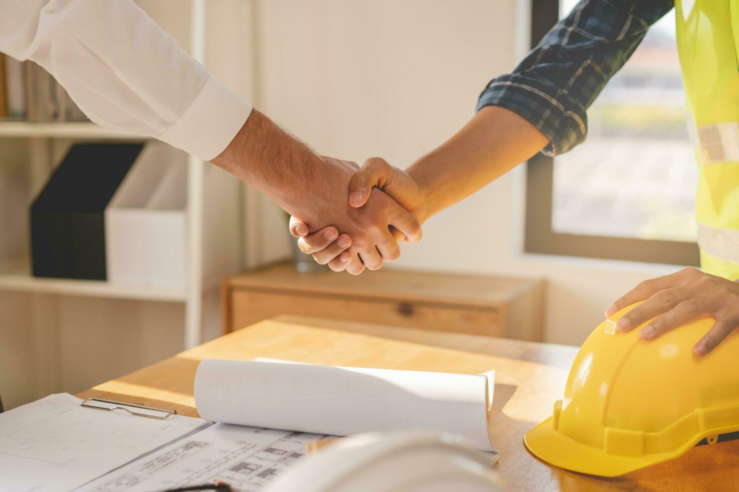 Successful team building asian young male, man or builder group handshake together at office after home project done, good deal. Happy business people, Worker meeting, shaking hands and success. photo