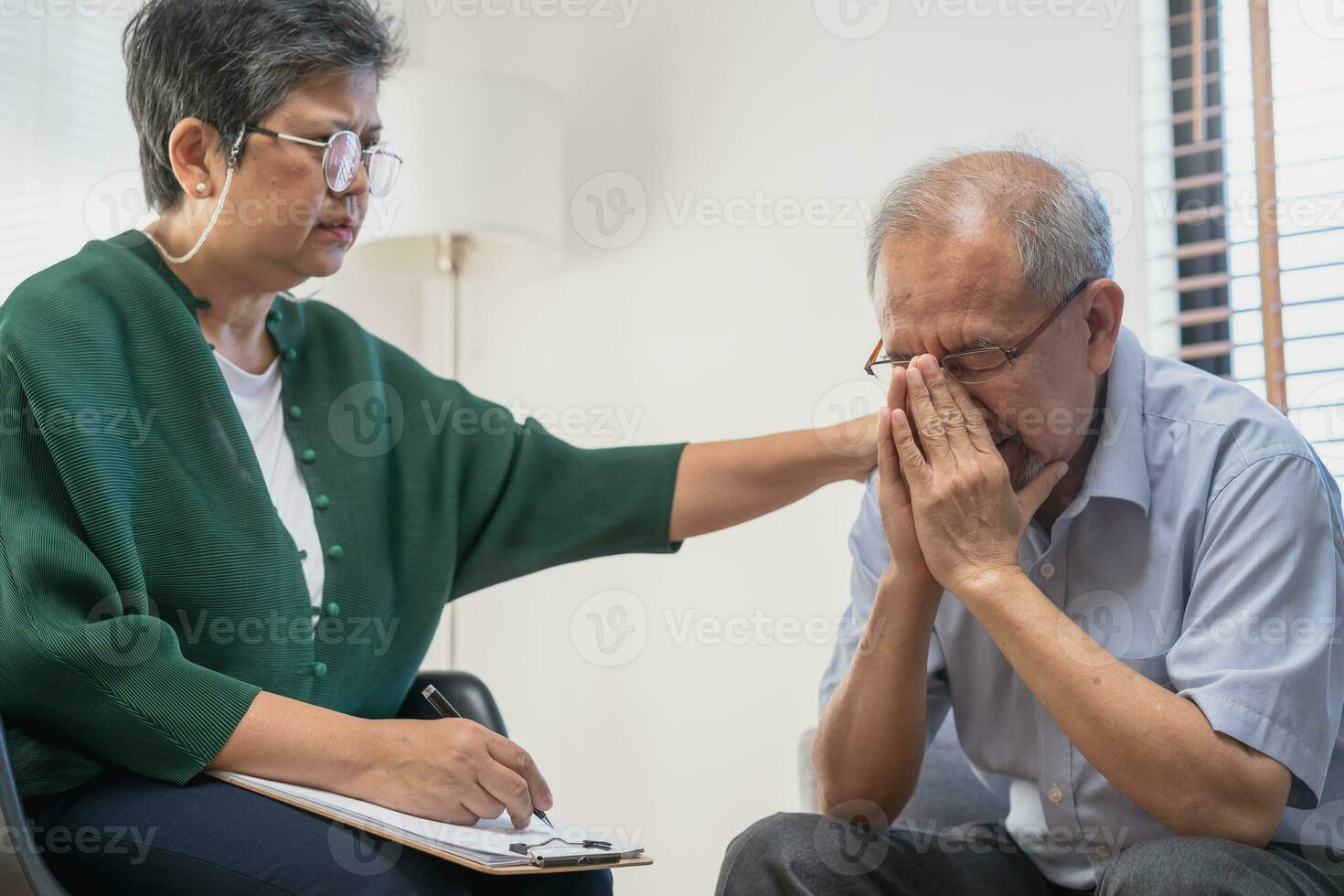 Psychology, depression people. Elderly asian adult man, men consulting with psychologist ,psychiatrist while elderly, old patient counseling mental with doctor woman at clinic. Encouraging, therapy. photo