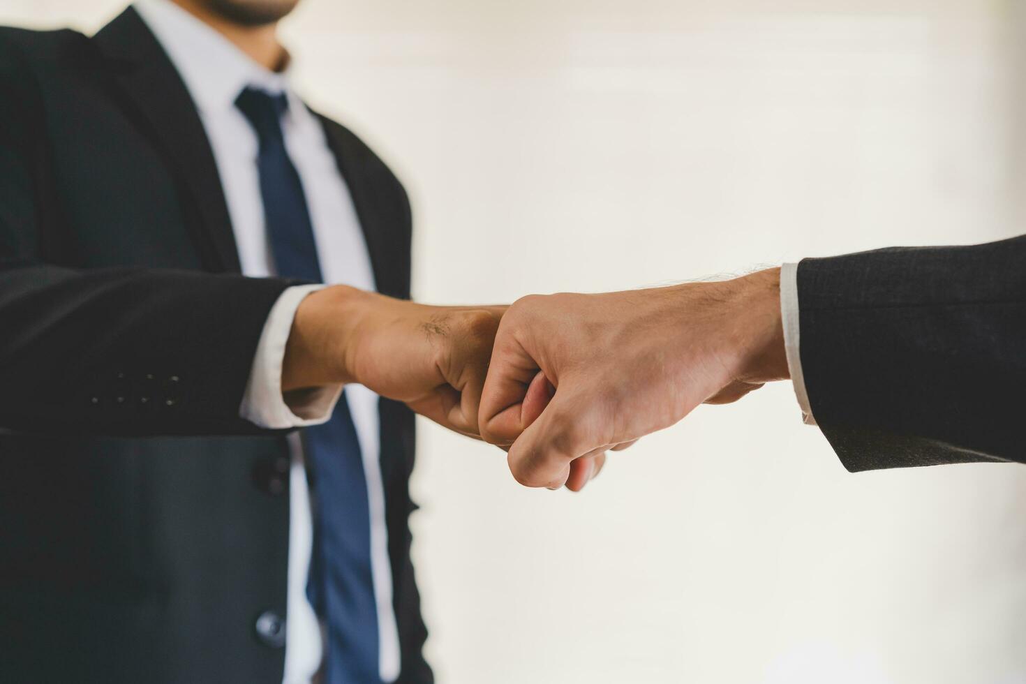 Congrats, business partnership people, two asian and caucasian young man fist bumping, shaking hands together with partnership, customer or colleague after work is done, successful. Worker meeting. photo