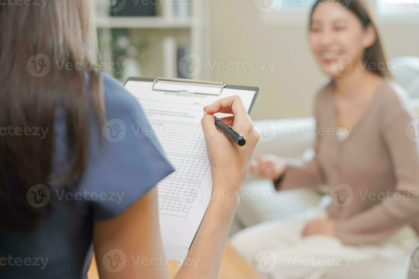 Psychology, depression. Sad, suffering asian young woman consulting with psychologist, psychiatrist while patient counseling mental with doctor woman taking notes at clinic. Encouraging, therapy. photo