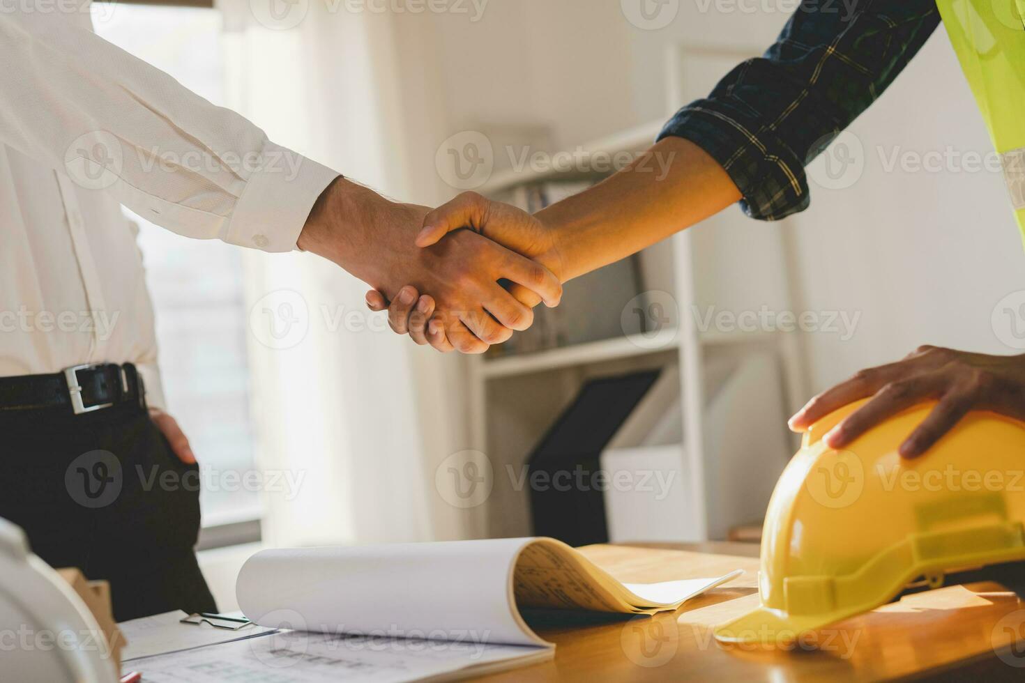 Successful team building asian young male, man or builder group handshake together at office after home project done, good deal. Happy business people, Worker meeting, shaking hands and success. photo