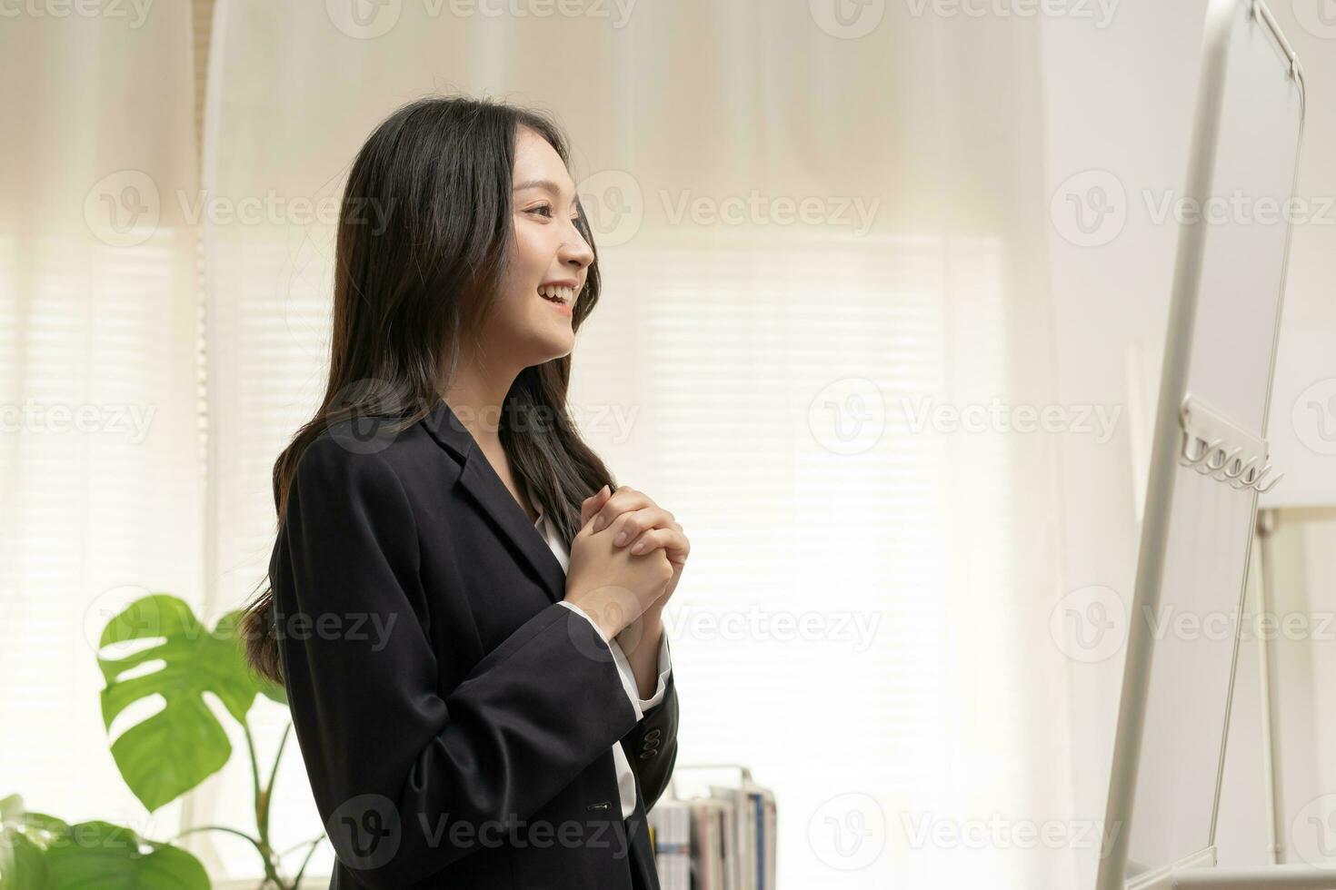 Confident, cheer up asian young woman standing in suit formal, smiling look in reflection mirror at home before job interview of change career, recruitment employee or staff in company, corporate. photo