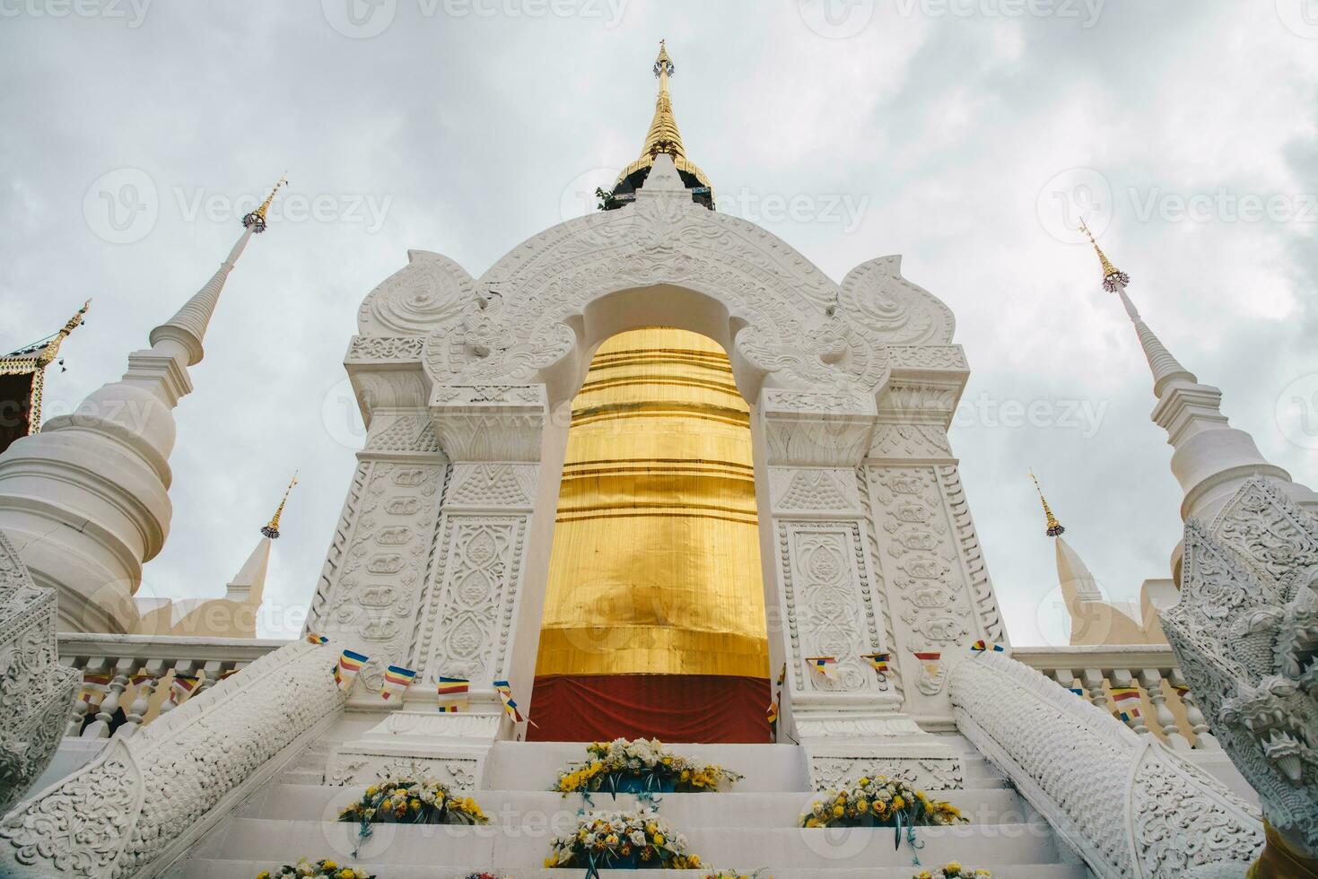 The golden buddhist pagoda in Wat Suan Dok this important monastery enshrines one half of a sacred Buddha relics in Chiang Mai province of Thailand. photo