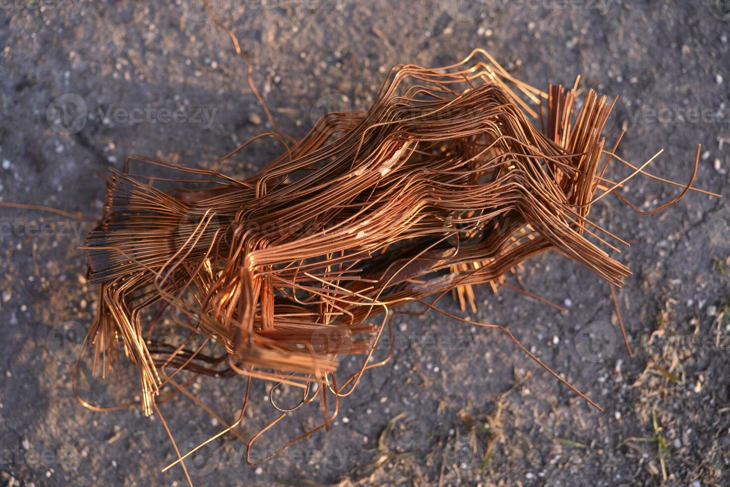 A bundle of copper wire in his hand. Copper scrap. Shiny red copper wire. photo