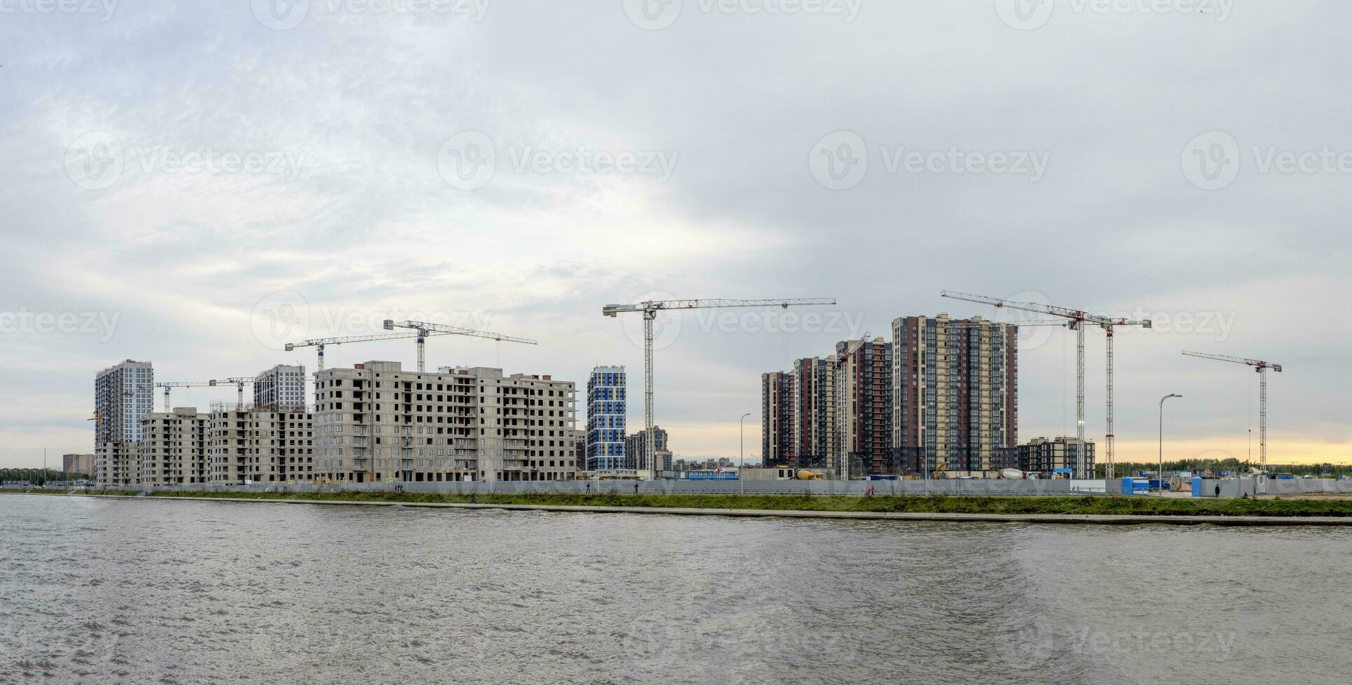 Construction work site and high rise building. High-rise building under construction. Reinforced concrete frame. photo