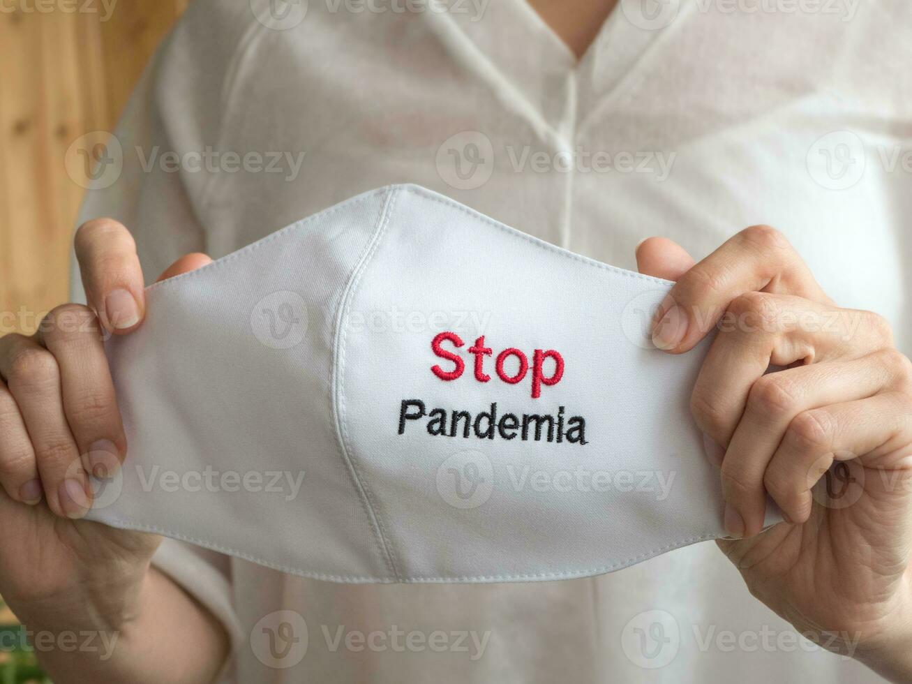 Coronavirus concept with medical mask and sign Stop Pandemia photo