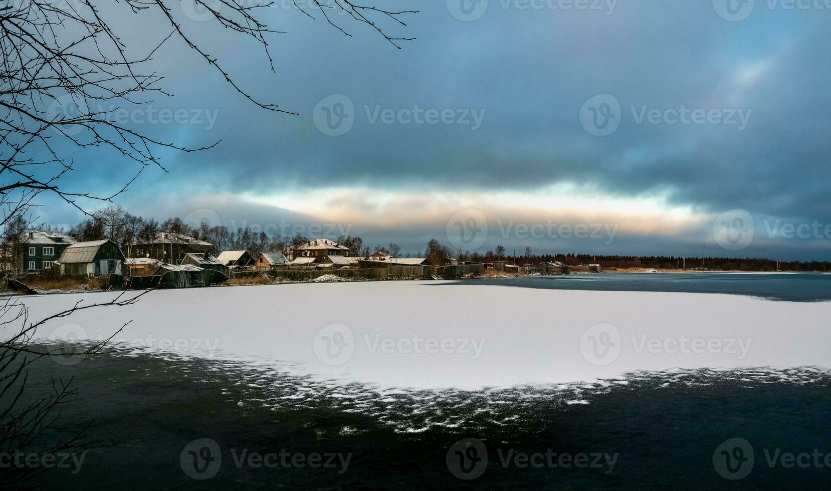 Panoramic winter view with old houses near a snow-covered lake. Authentic Northern city of Kem in winter. Russia photo