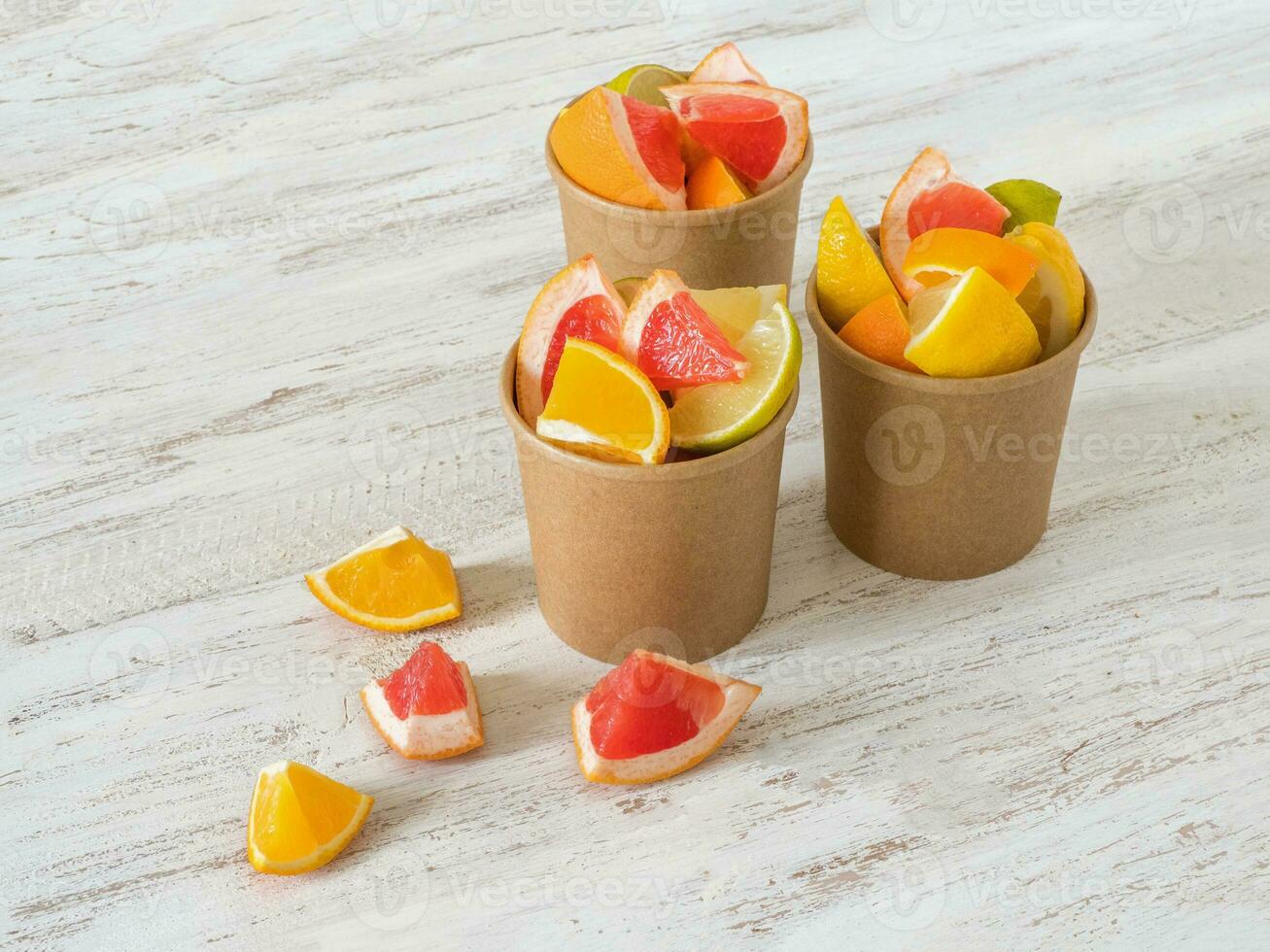 Citrus slices in a environmental paper cups. Vitamin C drink. Strengthening the immune system concept photo