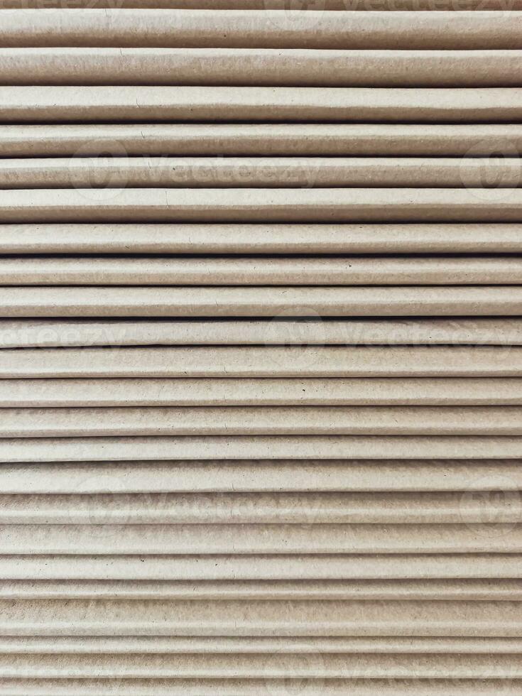 Side view of a corrugated cardboard. Cardboard boxes are folded on a pallet. Corrugated cardboard sheets are one by one. photo