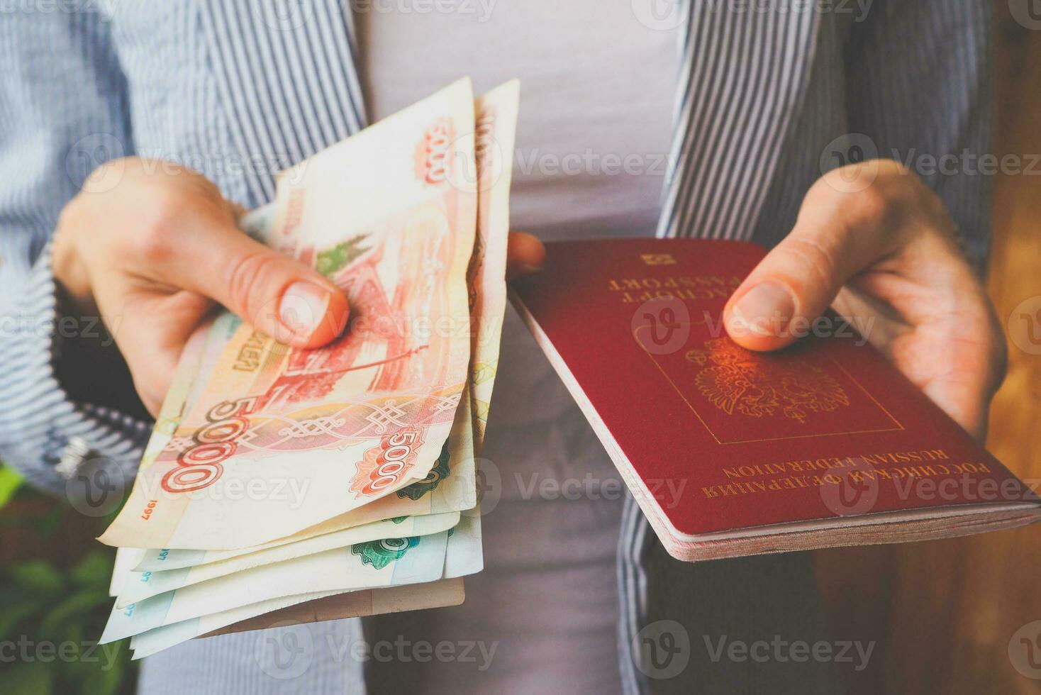 Paper money rubles and a Russian passport in women's hands photo