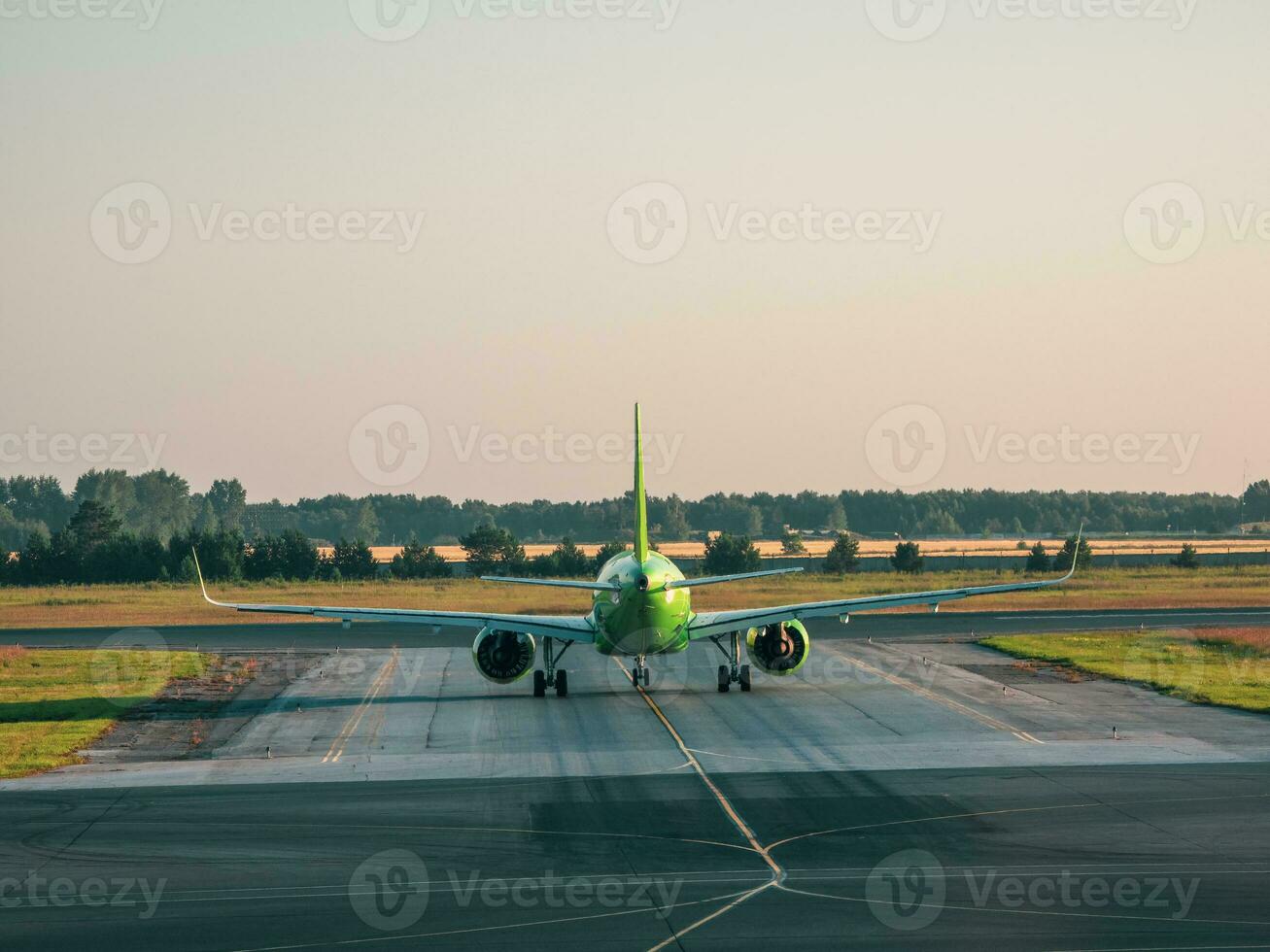 The plane before takeoff. White plane is on takeoff in the morning. photo