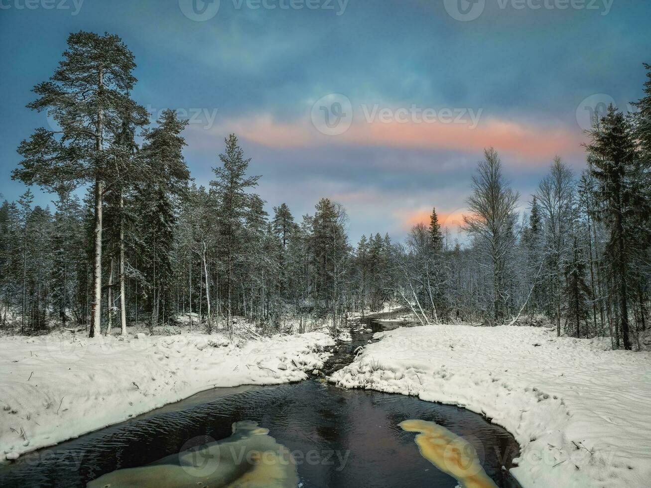 Winter mountain river in Karelia flows through the forest. The power of wild majestic nature. photo