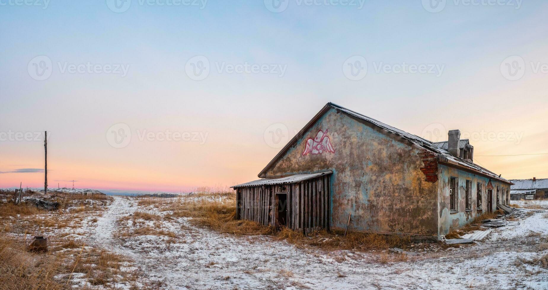 Abandoned house against the Arctic sky. Old authentic village of Teriberka. Kola peninsula. photo