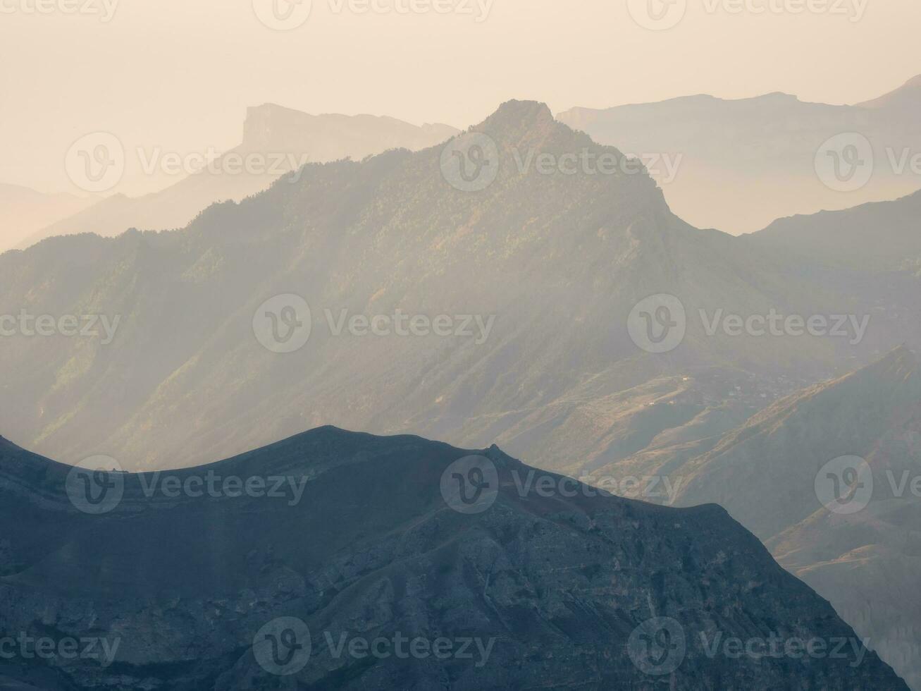 Soft pink sunset in mountain landscape. Silhouette of the evening mountains at sunset. photo