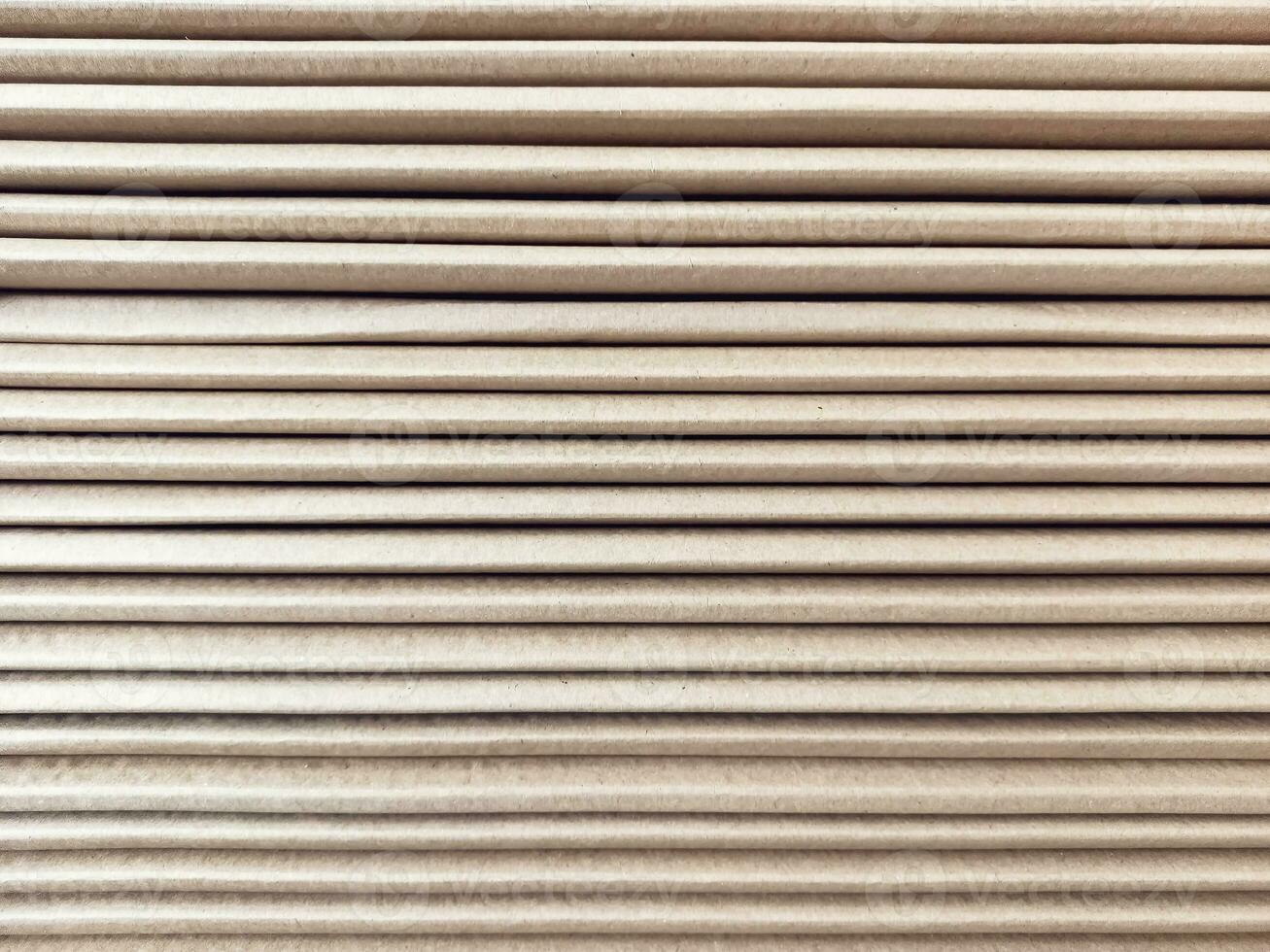 Side view of a corrugated cardboard. Cardboard boxes are folded on a pallet. Corrugated cardboard sheets are one by one. photo