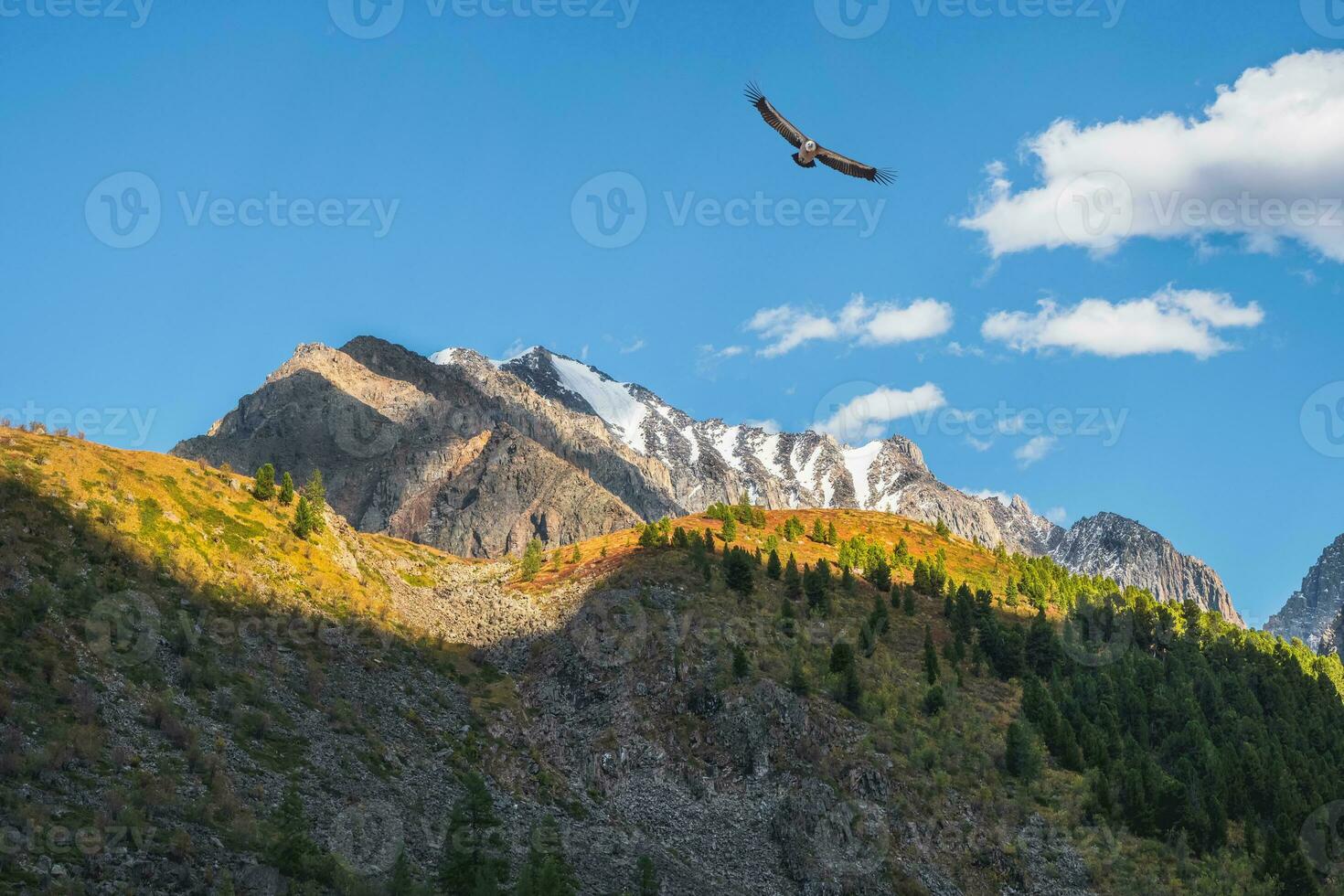 Beautiful mountain scenery with golden light on slopes snowy mountains. Scenic mountain landscape with illuminating color in blue sky. photo