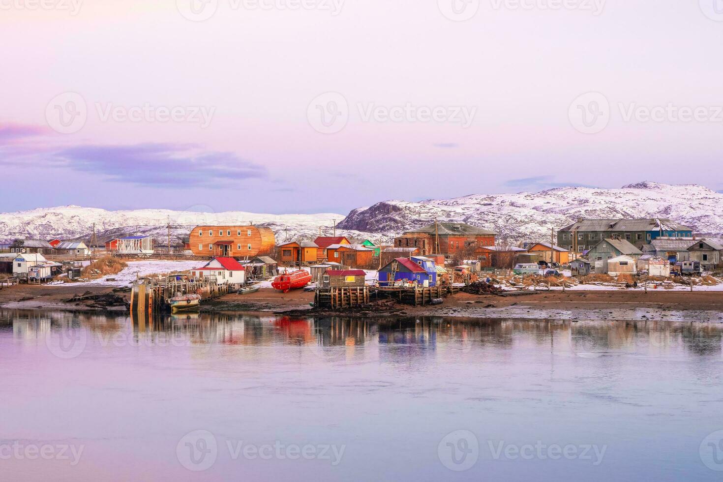 Soft pink halftones of an Arctic village on the shore of the Barents sea. Amazing view of winter Teriberka. Russia photo