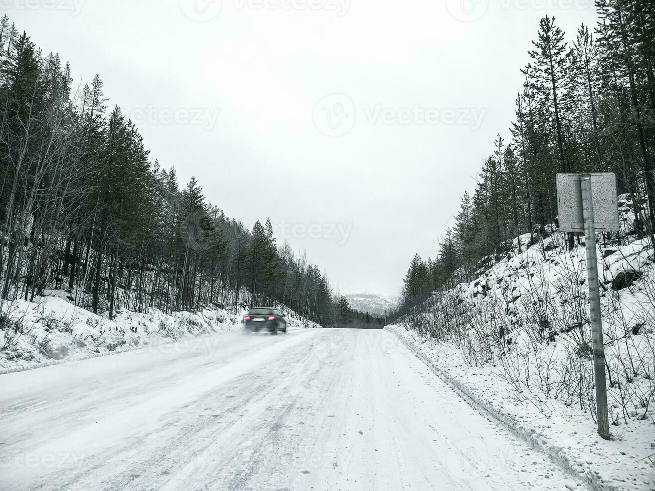 The car is in motion. Slippery steep uphill climb. photo