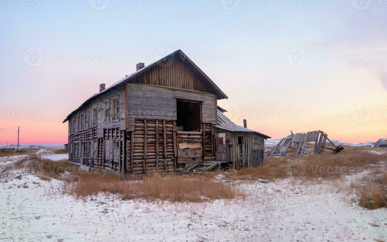 Abandoned house against the Arctic sky. Old authentic village of Teriberka. Kola Peninsula. Russia. photo