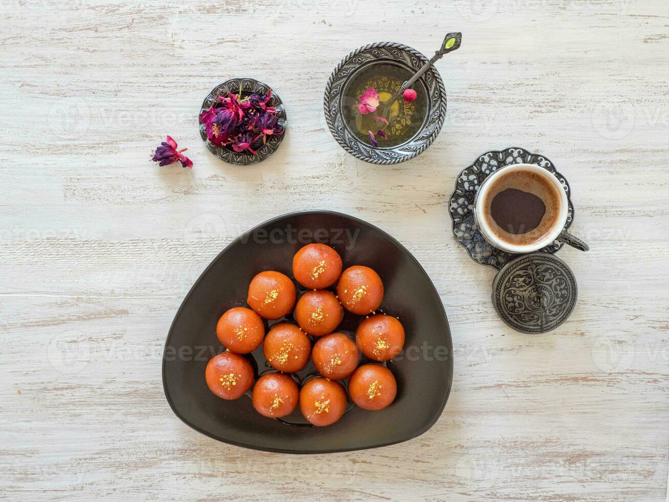 Gulab Jamun - Traditional Indian sweets on a white wooden table photo