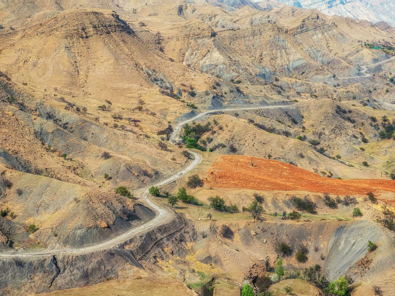 Serpentine road across the red valley. Aerial view. photo