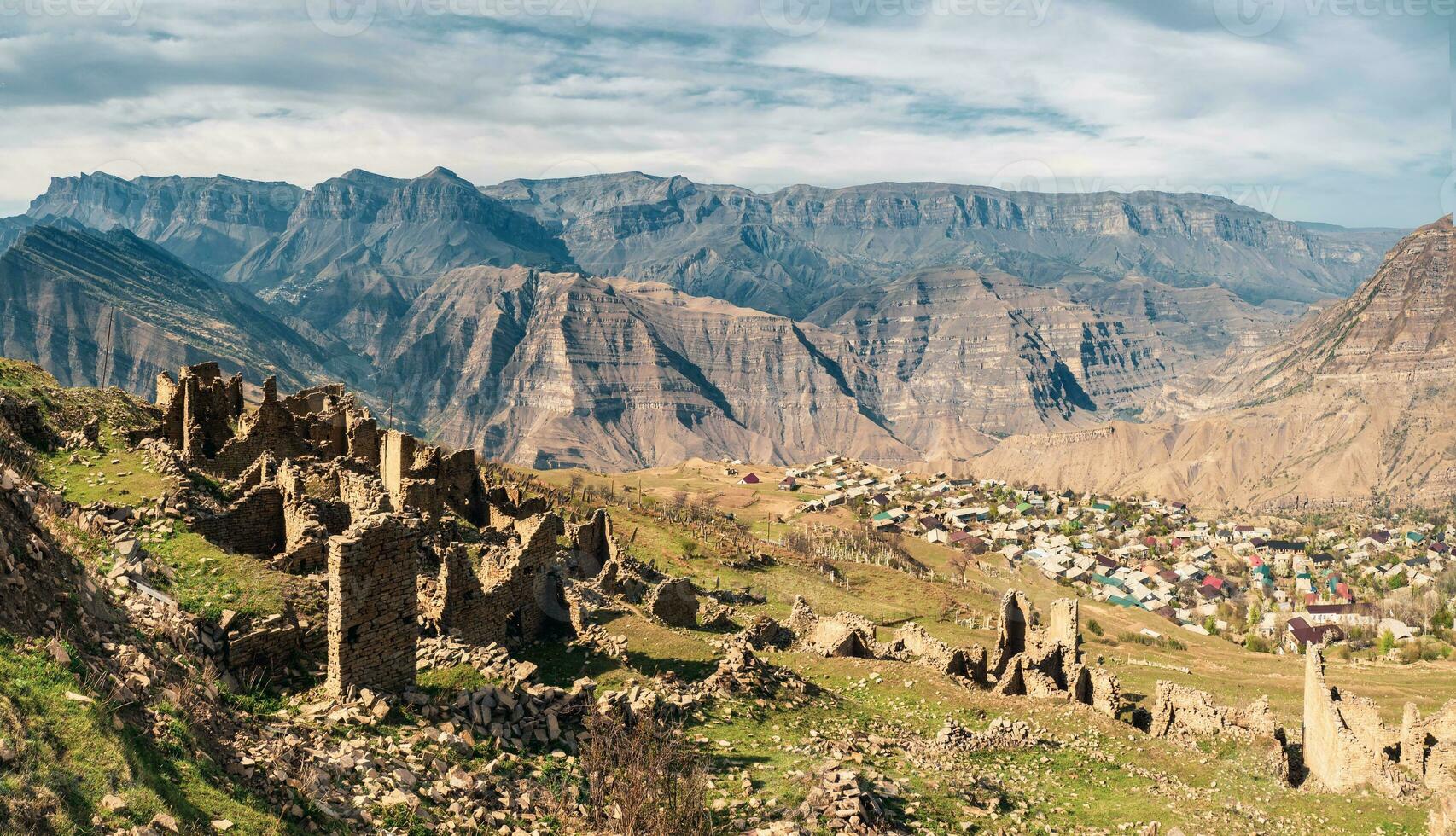 Summer view of ruins and towers of the aul ghost Goor in Dagestan in the evening light. photo