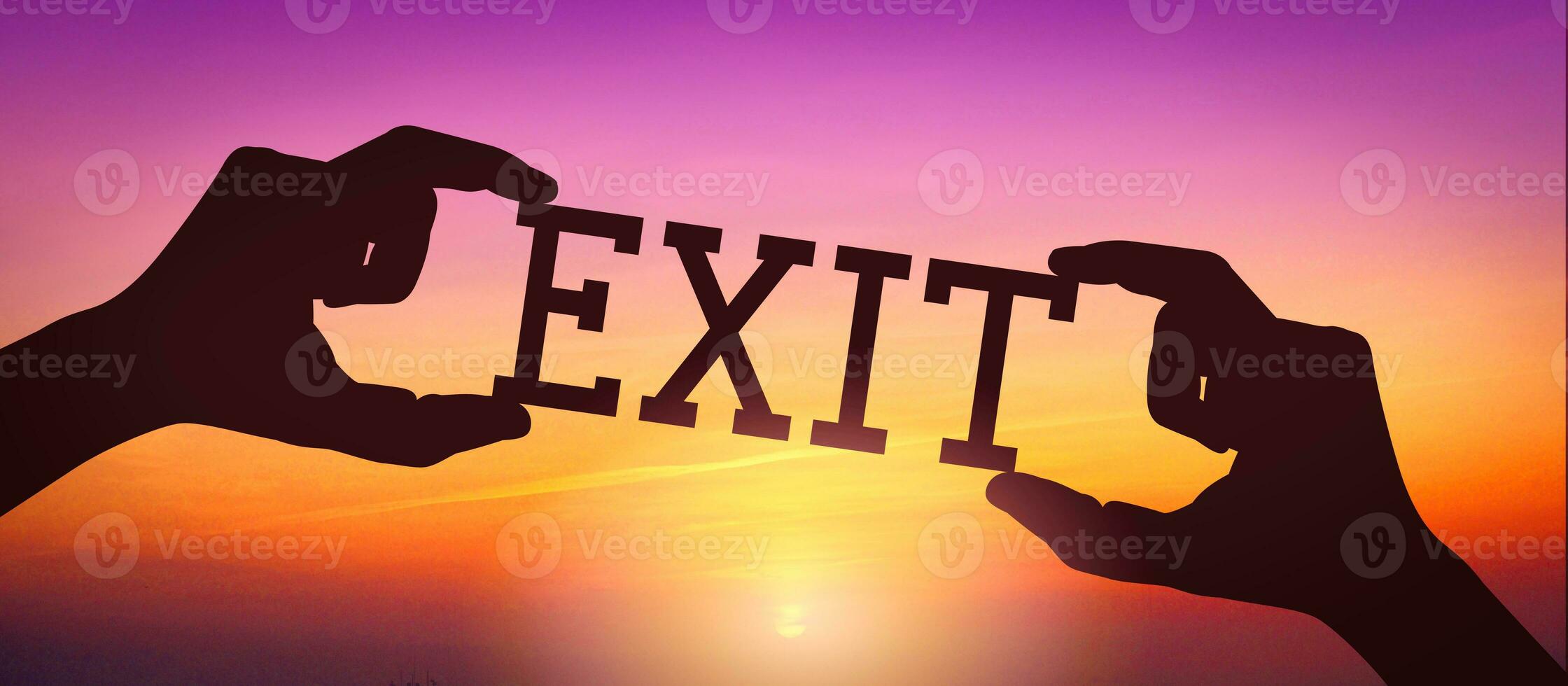 Exit - Human Hands Holding Black Silhouette Word photo