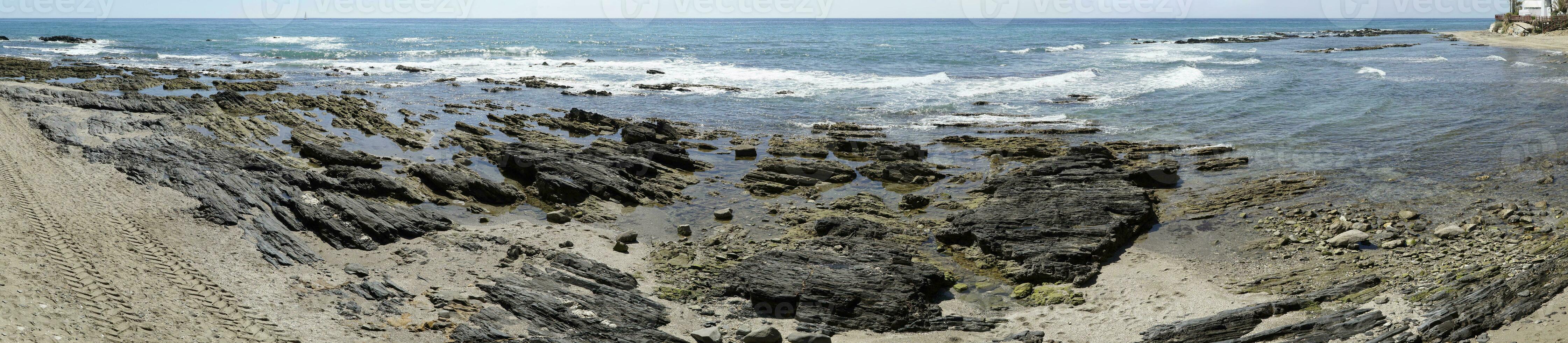 Rocks on Sea Shore in Cala de Mijas, Spain - Panorama photo