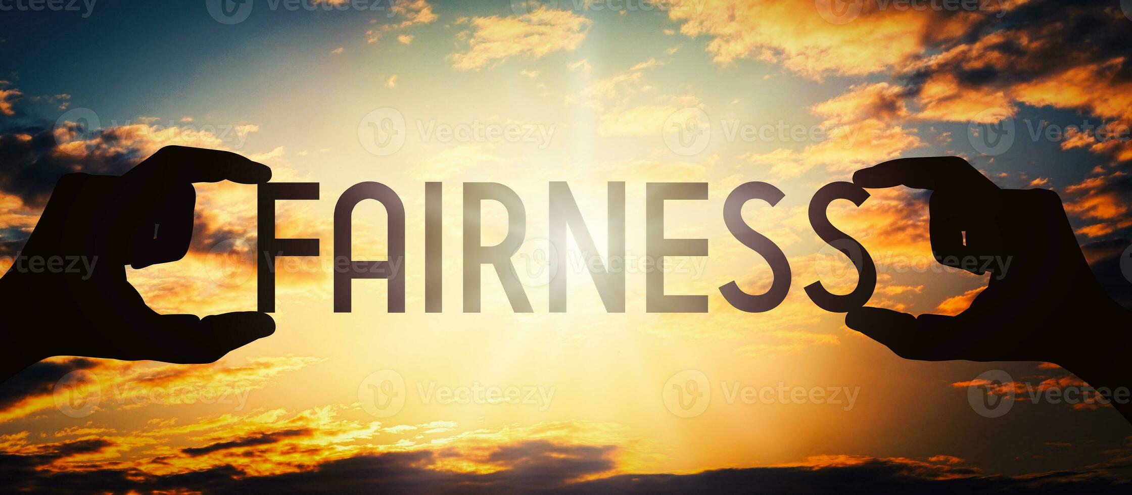 Fairness - Human Hands Holding Black Silhouette Word photo