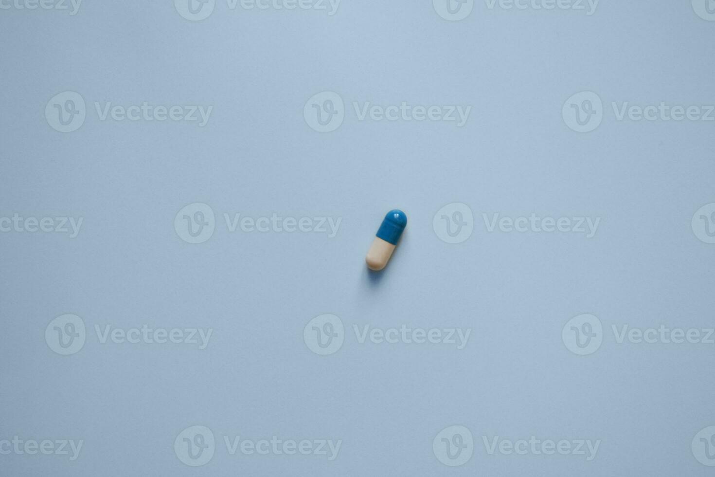 pill capsule on a blue background, medication, medical workers day, medical care, banner for the hospital photo