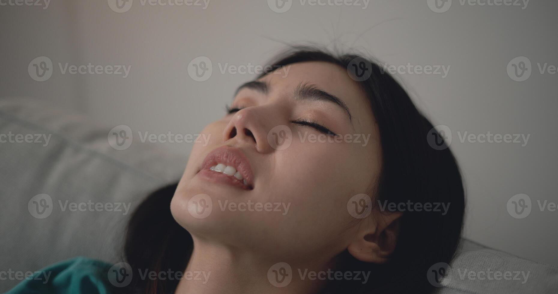 Asian Young woman sleeping on sofa in living room photo