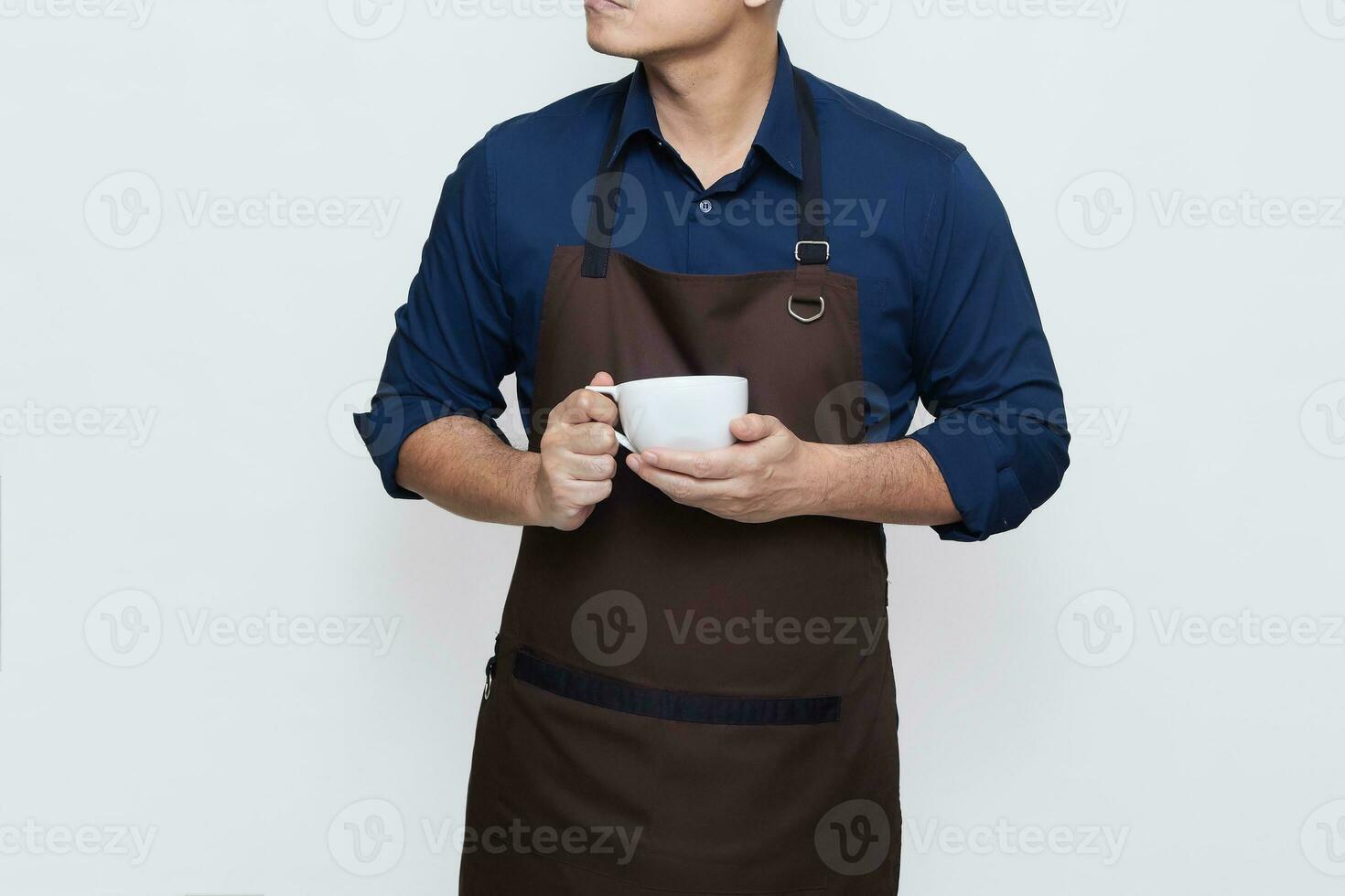 Asian Man wearing Apron in casual stylish clothing, standing upright pose while holding a cup of coffee or tea, calm and confident gesture, no face isolated white background photo