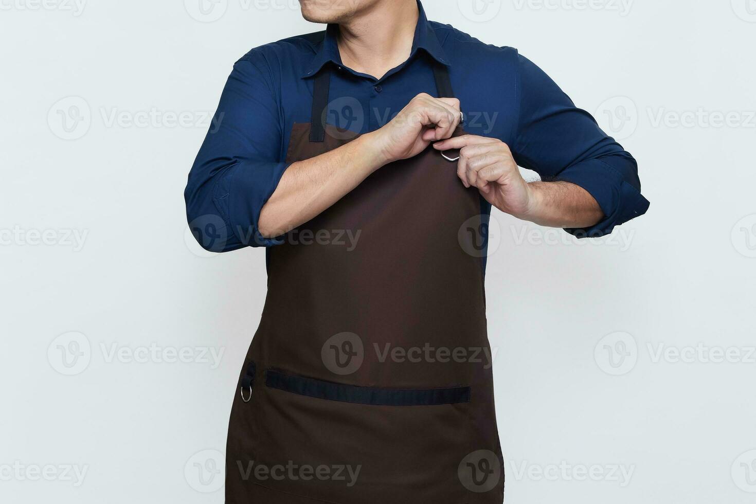 Asian Man wearing Apron in casual stylish clothing, standing tall pose with both hands tightening the apron strings , ready to work, no face isolated white background photo